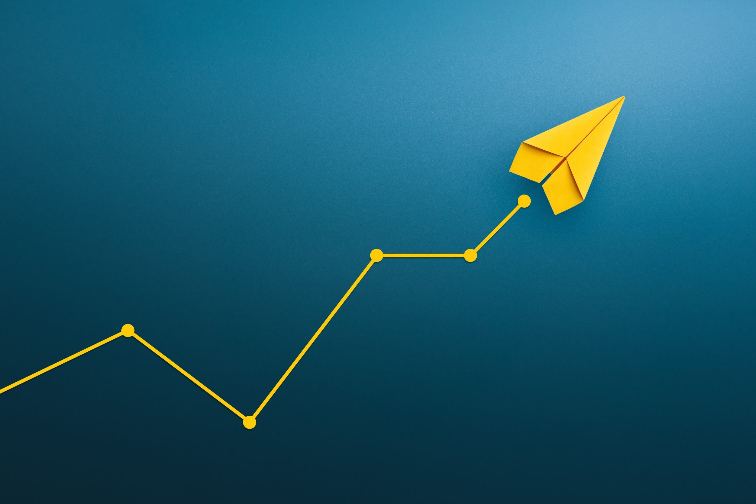 learning or relearning is a journey in speech therapy. A blue background with a yellow paper plane tracing a yellow pattern with an upward trend